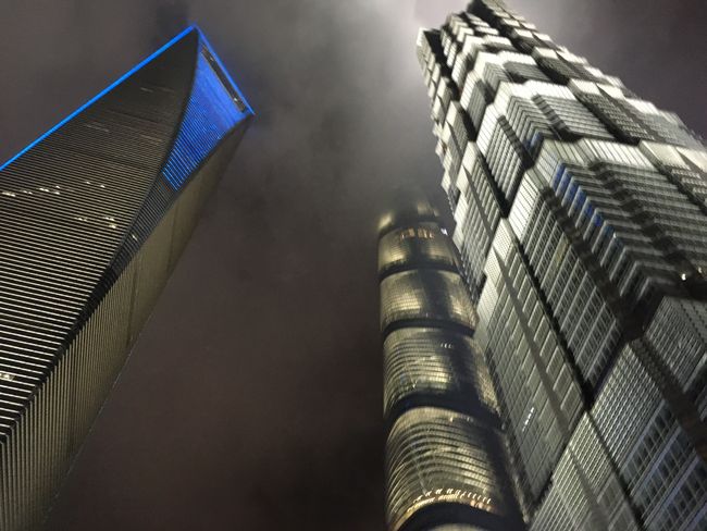 That's why they're called "skyscrapers". View of the Shanghai Tower and the "bottle opener" from below.