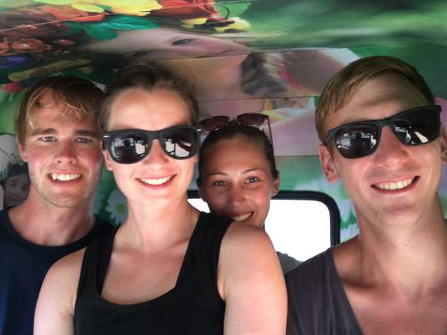 Traveling by tuk-tuk with four people