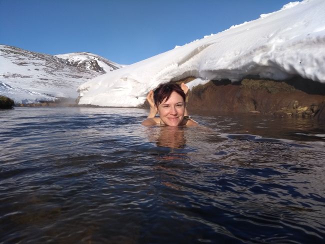 Bathing in the hot river in the snowy landscape of Reykjadalur
