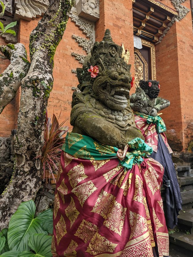 A statue dressed in traditional attire as part of a temple