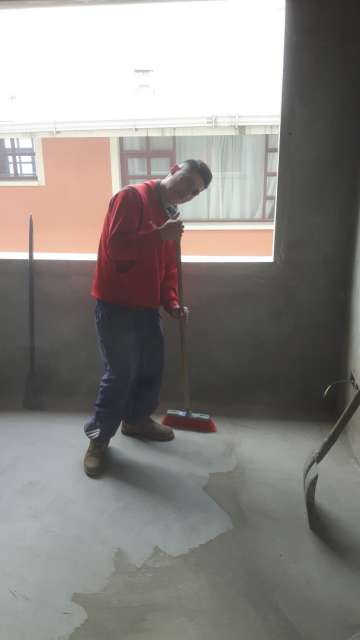 Milton, who is responsible for maintenance work, cleaning one of the rooms in the future living area